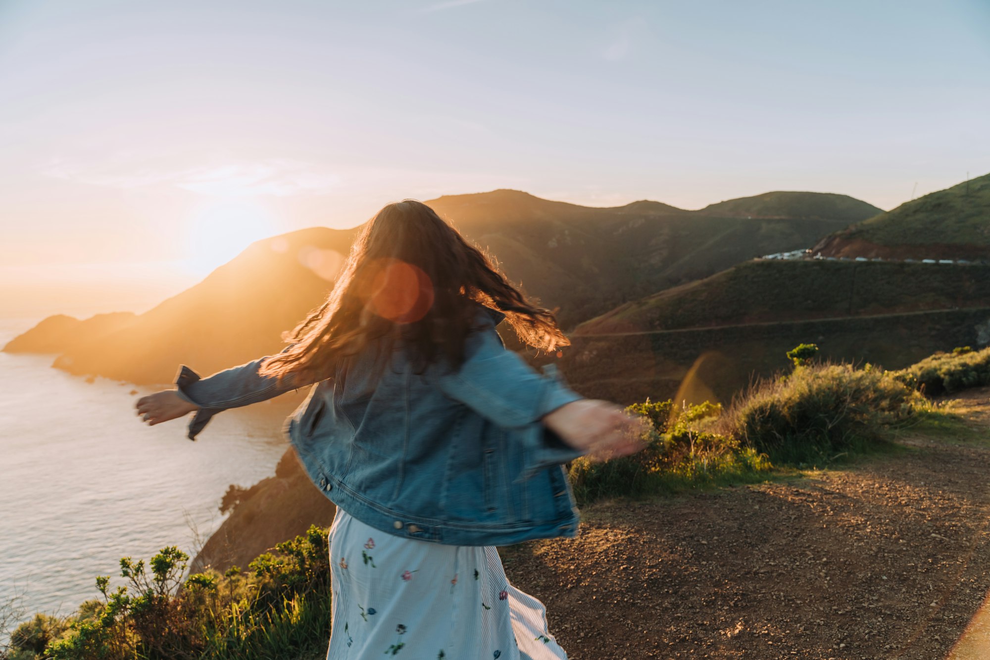 Happy traveling woman in the sunshine feeling free